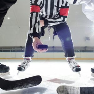 hockey-referee-with-puck-standing-ice-rink-two-players-with-sticks-waiting-moment-be-first-shoot-it-training_274679-16904